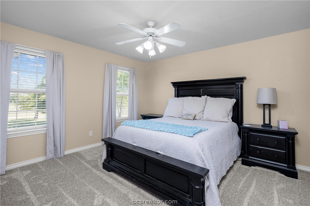 6400 Koppe Bridge Road College Station, TX 77845 - Photo 31 of 47 Upstairs bedroom featuring a ceiling fan and light carpet.