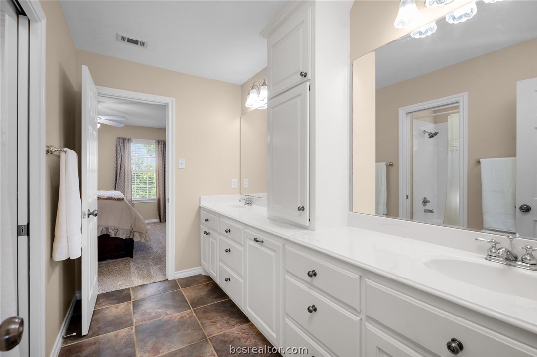 6400 Koppe Bridge Road College Station, TX 77845 - Photo 33 of 47 Jack and Jill bathroom with double vanity and a shower.