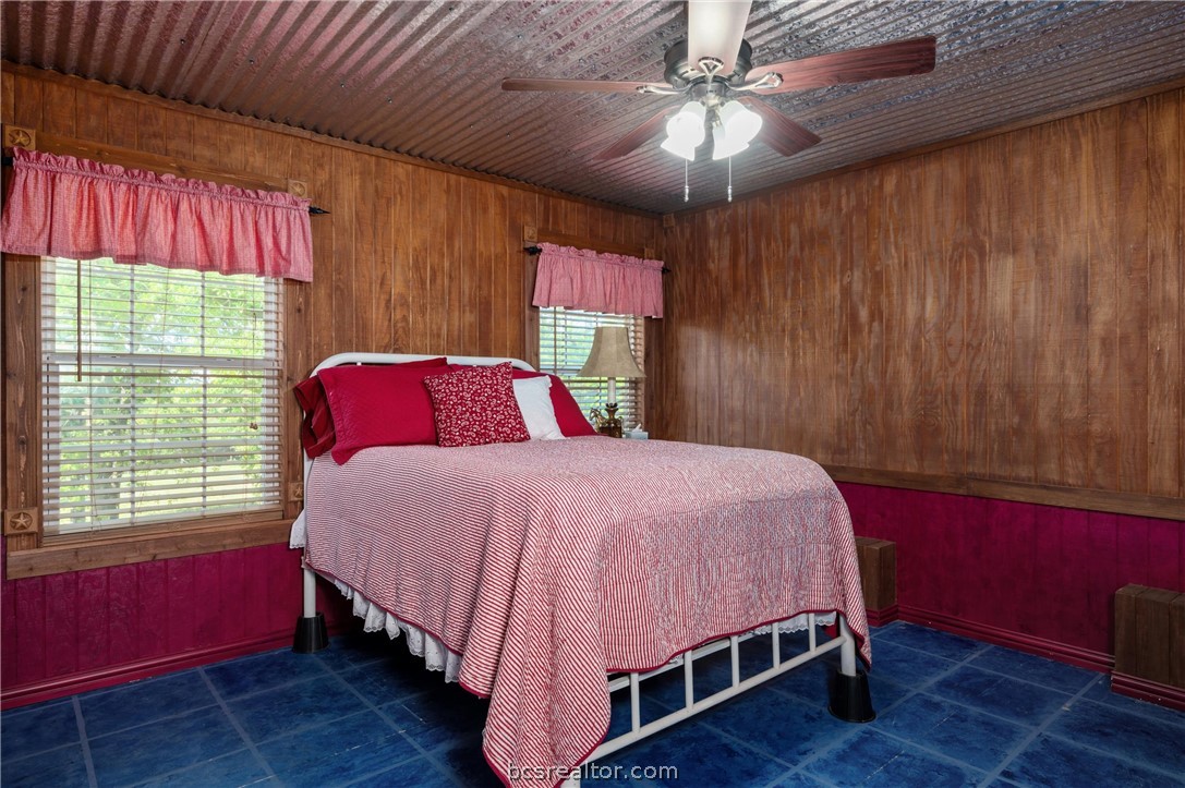 6400 Koppe Bridge Road College Station, TX 77845 - Photo 34 of 47 Upstairs bedroom/craftroom featuring wood walls and ceiling fan. Converted from attic space.