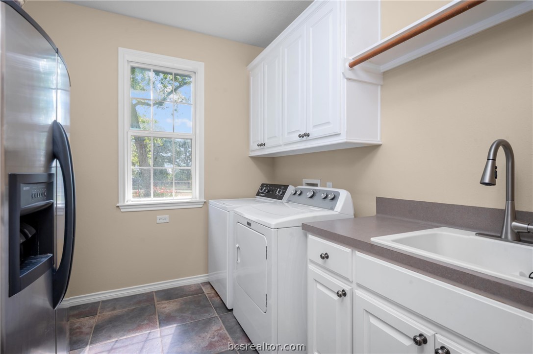 6400 Koppe Bridge Road College Station, TX 77845 - Photo 35 of 47 Laundry room with washing machine and clothes dryer and cabinet space.