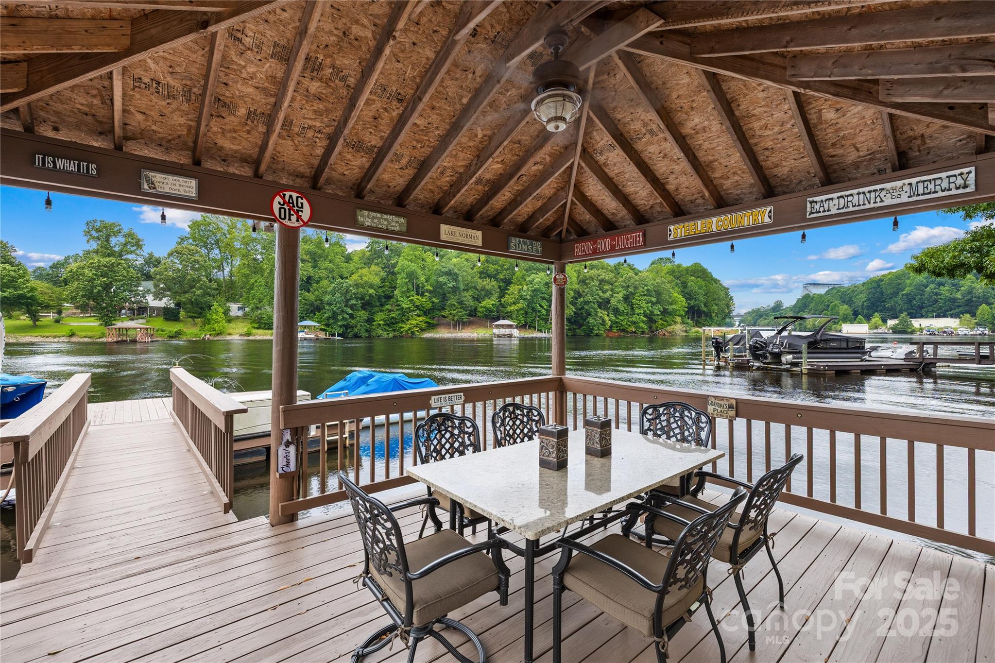 3601 Andover Place Terrell, NC 28682 - Photo 11 of 48 a view of a patio with table and chairs under an umbrella with a barbeque