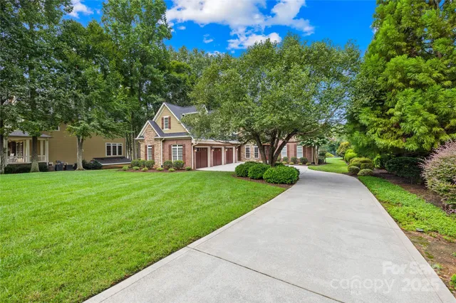 a living room with furniture a chandelier and a fireplace