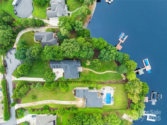 a view of a patio with table and chairs potted plants and a large tree
