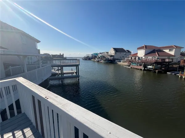 a view of balcony with wooden floor and fence