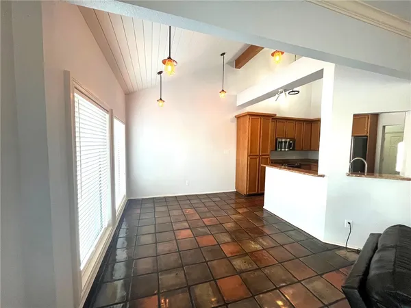 a kitchen with stainless steel appliances granite countertop a refrigerator stove and microwave