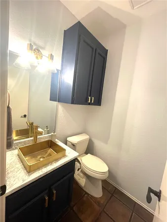 a large bedroom with a bed and a chandelier