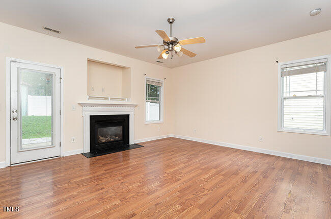 3529 Sunbright Lane Raleigh, NC 27610 - Photo 5 of 30 an empty room with chandelier fan and windows