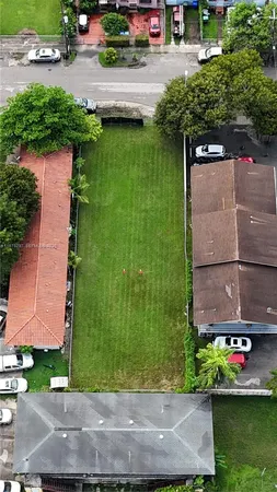 an aerial view of a house with a yard basket ball court and outdoor seating