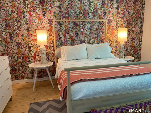 a bedroom with a bed and a table chair