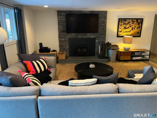 a living room with furniture fireplace and a flat screen tv