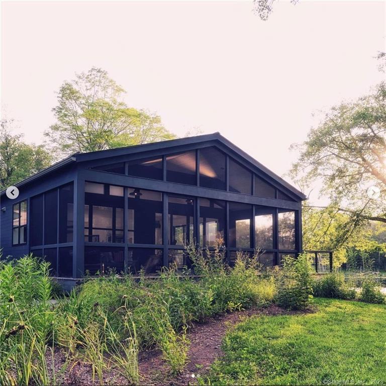 8 Chester Road Warren, CT 06754 - Photo 2 of 28 a view of a house with brick walls and a yard with plants