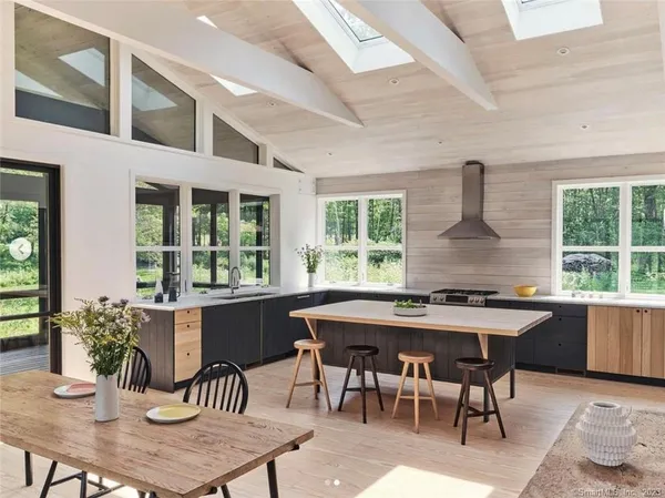 a dining room with furniture window and wooden floor