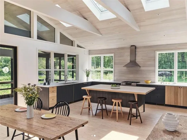 a dining room with furniture window and wooden floor