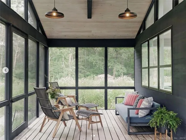 a living room with furniture and floor to ceiling windows