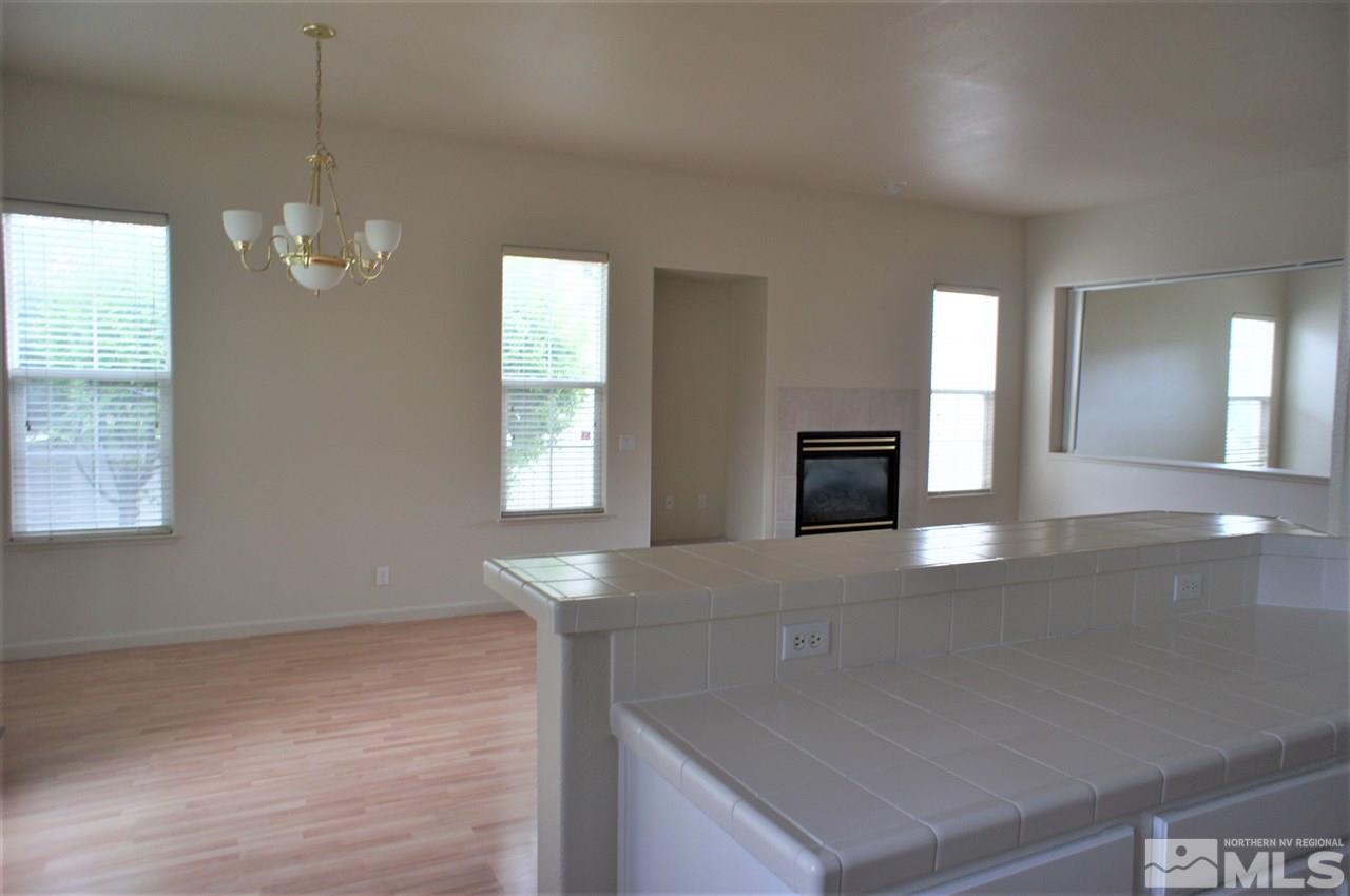 1075 Waverly Drive Reno, NV 89519 - Photo 8 of 17 an empty room with windows and fireplace