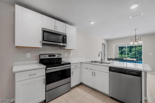 a kitchen with a sink stove and microwave