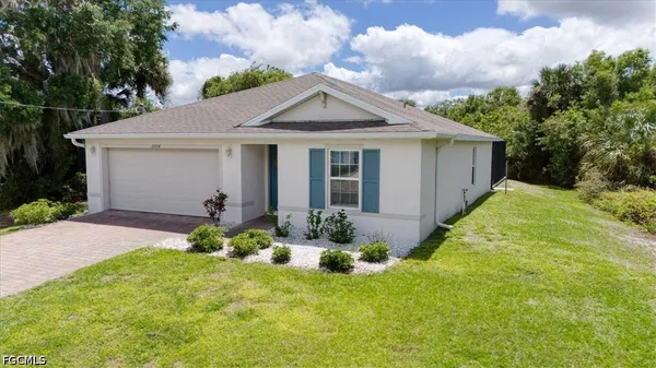 a front view of house with yard and green space