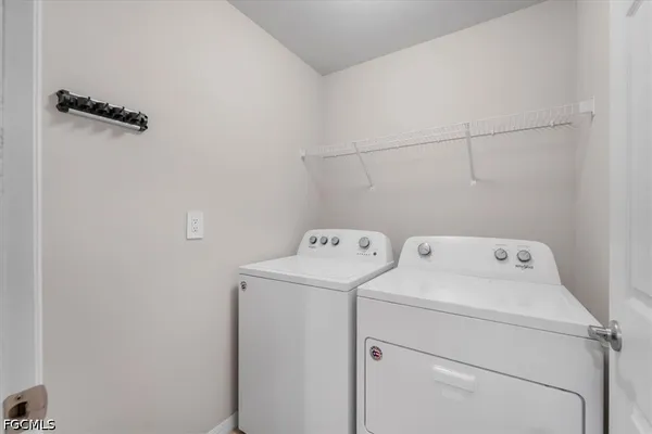 a view of storage and utility room with washer and dryer