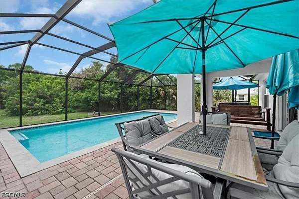 a view of an outdoor sitting area with furniture and umbrella