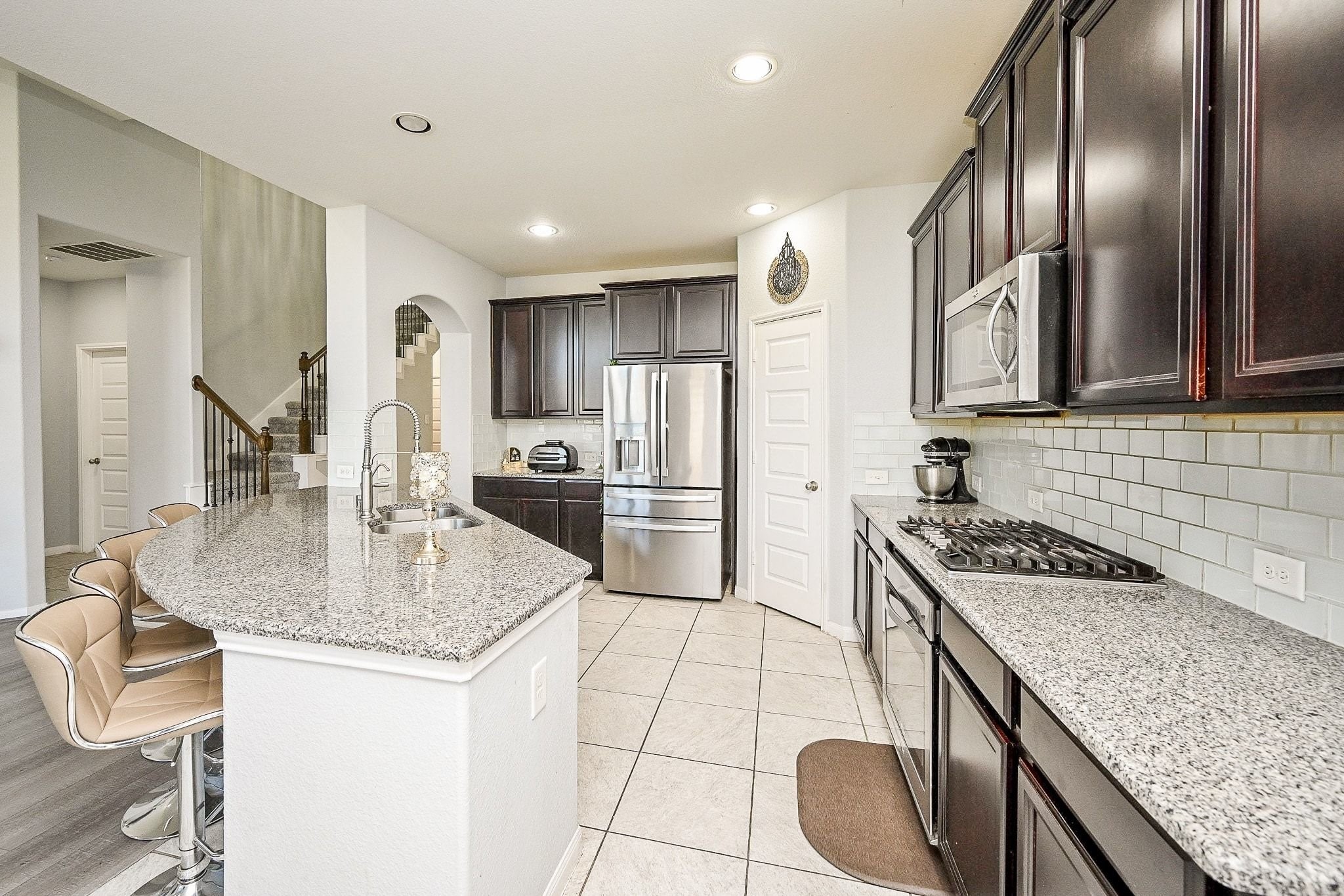 7042 Sliding Rock Circle Spring, TX 77379 - Photo 12 of 44 Stunning chef's kitchen with sleek countertops, modern appliances, and ample storage—perfect for culinary enthusiasts.
