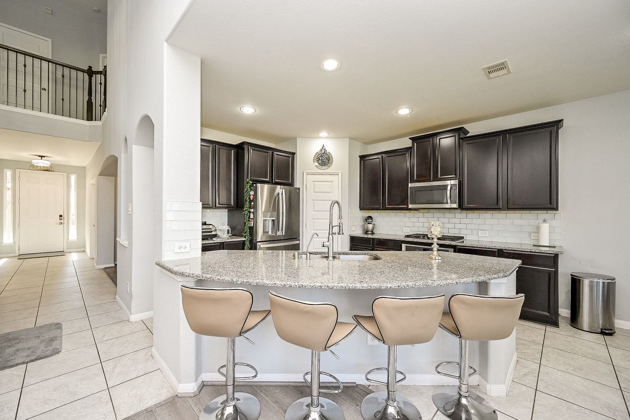 7042 Sliding Rock Circle Spring, TX 77379 - Photo 15 of 44 Savor your meals in this inviting kitchen, featuring a spacious island and modern appliances.