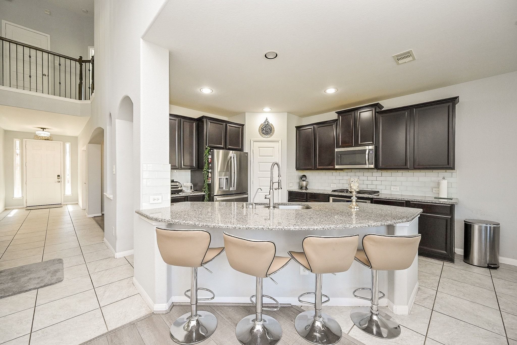 7042 Sliding Rock Circle Spring, TX 77379 - Photo 16 of 44 Inviting kitchen with sleek countertops and modern appliances, perfect for casual dining and entertaining.