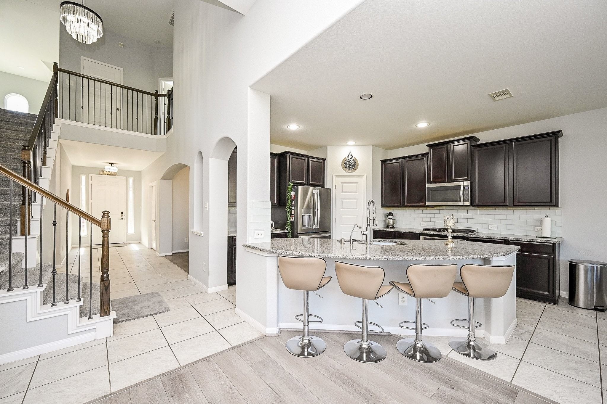 7042 Sliding Rock Circle Spring, TX 77379 - Photo 17 of 44 Savor delightful meals in this elegant kitchen, featuring a spacious island and sleek finishes, perfect for relaxation and entertaining.