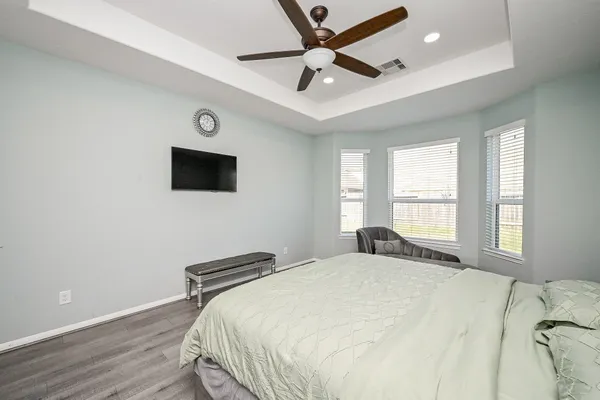 a bathroom with a tub a sink and a window
