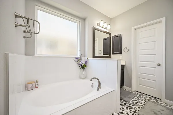 a bathroom with a double vanity sink a mirror and a