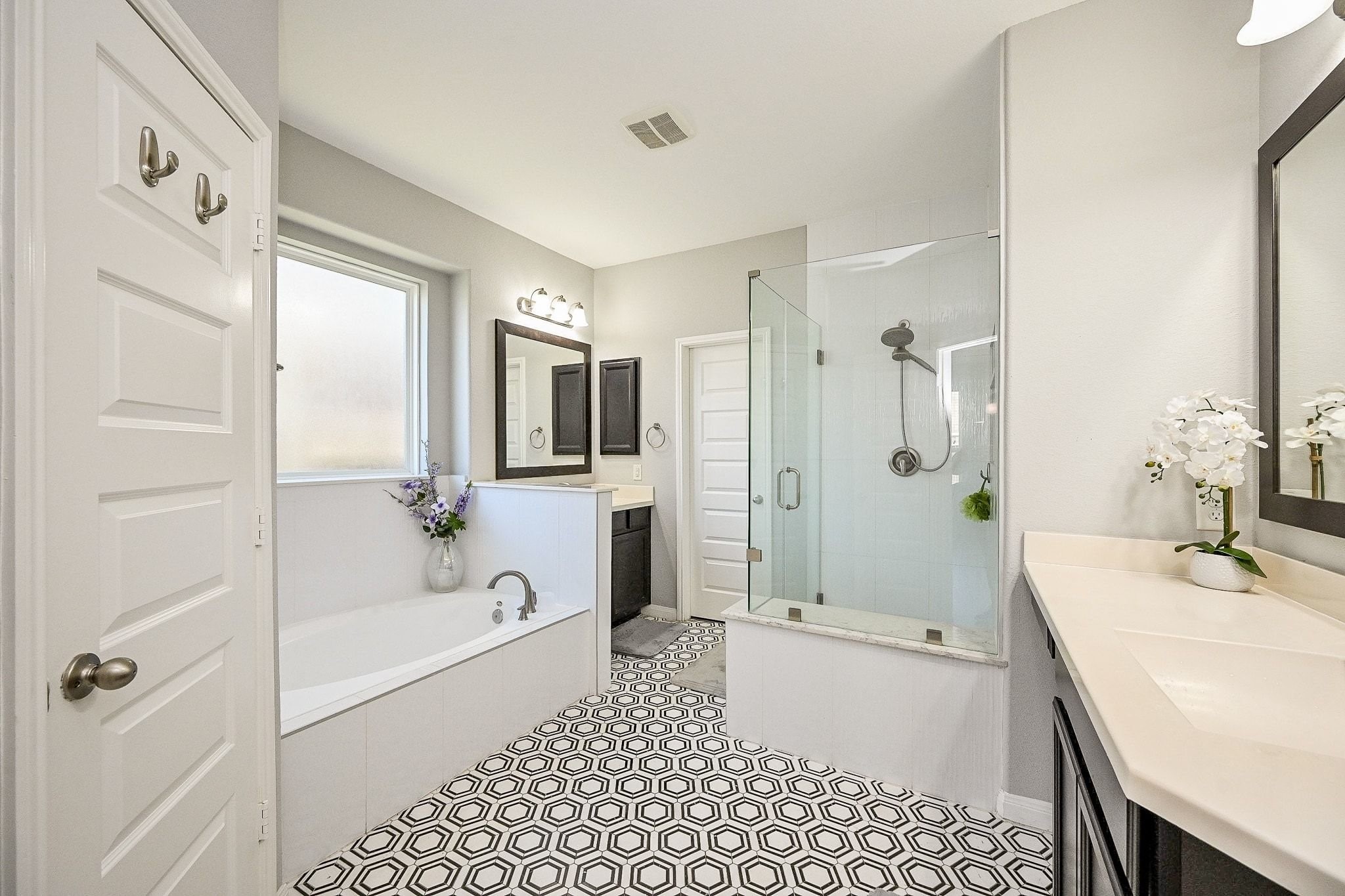 7042 Sliding Rock Circle Spring, TX 77379 - Photo 24 of 44 Experience elegance in the upgraded primary bathroom, featuring a sleek glass shower, inviting soaking tub, and modern fixtures.