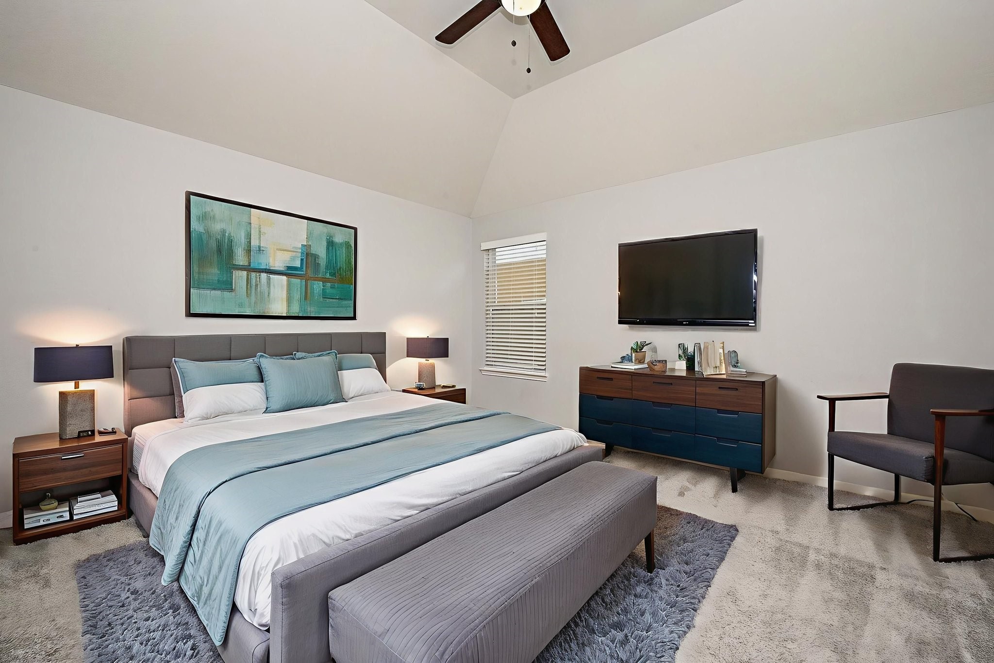 7042 Sliding Rock Circle Spring, TX 77379 - Photo 27 of 44 Cozy and modern bedroom with high ceilings, stylish decor, and ample natural light—perfect for relaxation.