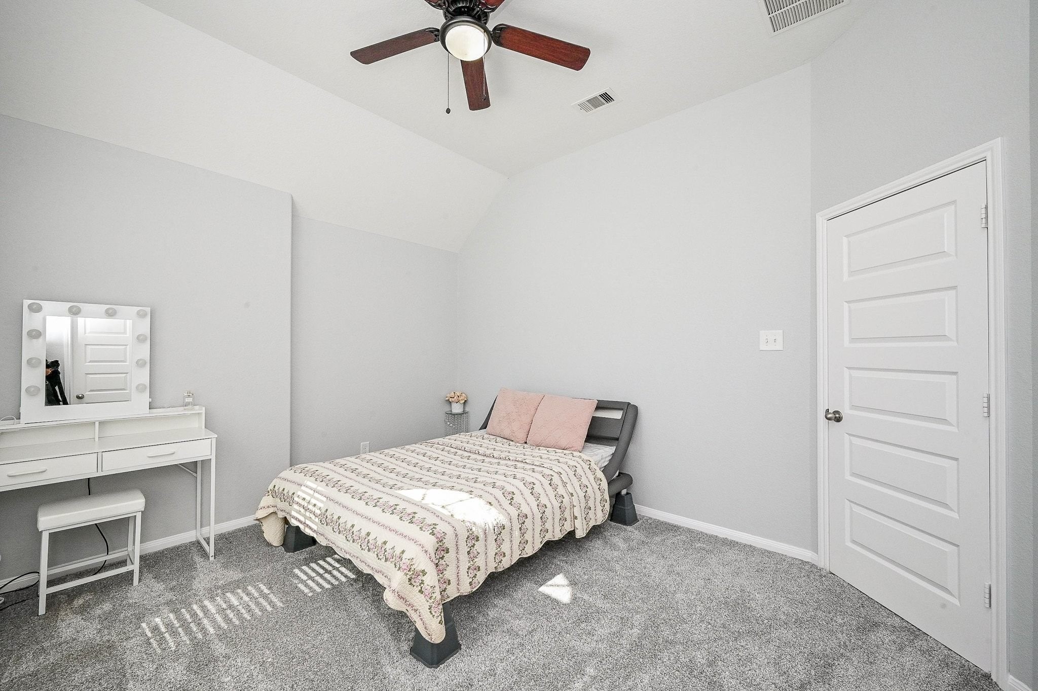 7042 Sliding Rock Circle Spring, TX 77379 - Photo 28 of 44 Inviting and cozy fourth bedroom with plush carpeting, abundant natural light, and a modern ceiling fan.