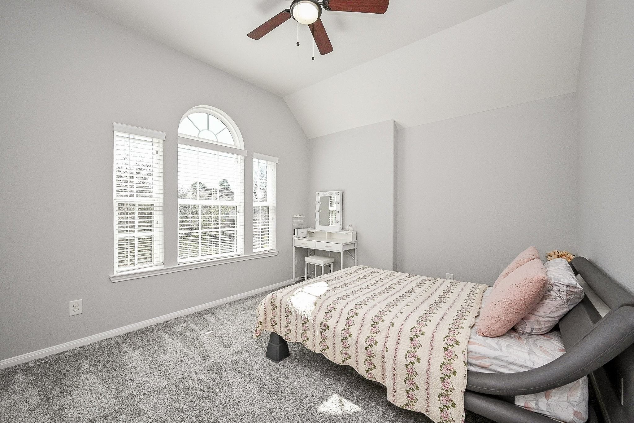 7042 Sliding Rock Circle Spring, TX 77379 - Photo 29 of 44 Bright and inviting bedroom with vaulted ceilings and a charming arched window, perfect for relaxation and comfort.