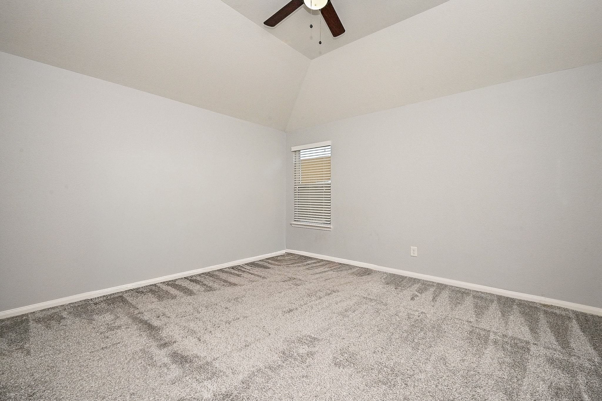 7042 Sliding Rock Circle Spring, TX 77379 - Photo 30 of 44 Versatile game room featuring fresh carpet, neutral walls, and a ceiling fan—perfect for entertainment or relaxation.