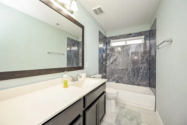 a view of a house with a backyard porch and sitting area