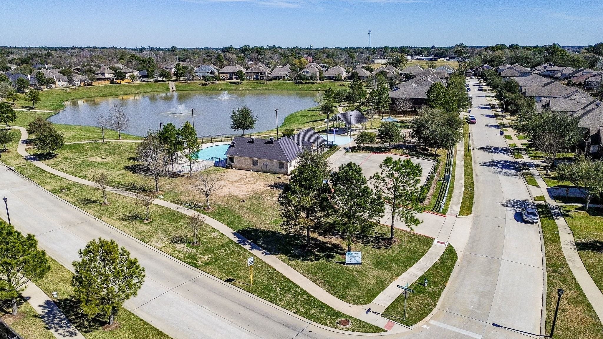 7042 Sliding Rock Circle Spring, TX 77379 - Photo 42 of 44 Enjoy a stunning view of the pool, serene lake, playground, and picnic area—perfect for family fun and relaxation.