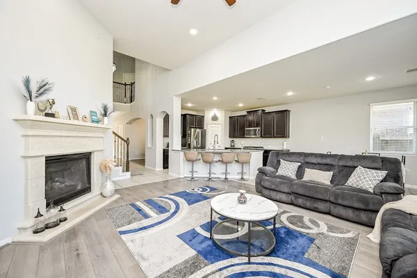 a living room with furniture and a fireplace