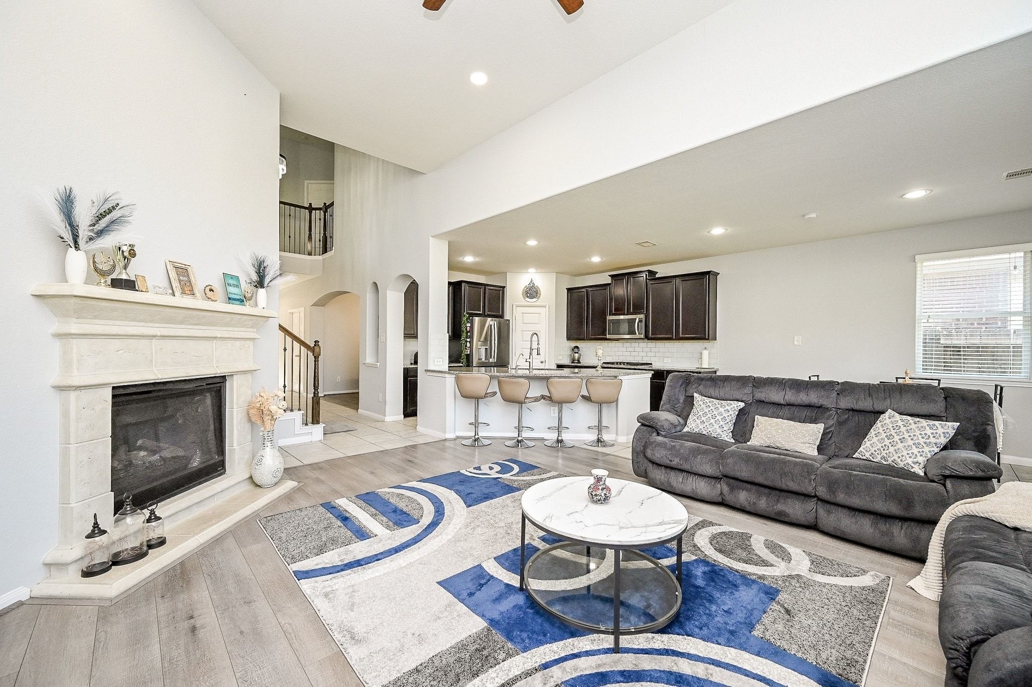 7042 Sliding Rock Circle Spring, TX 77379 - Photo 8 of 44 Spacious, inviting living area with a cozy fireplace and open layout, perfect for entertaining.