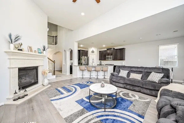 a living room with furniture a fireplace and a flat screen tv