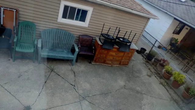 a view of backyard with barbeque grill and outdoor seating
