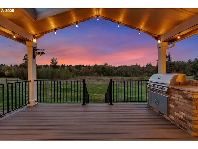 a view of a roof deck with a table and chairs