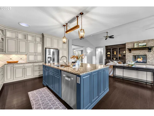 a kitchen with counter top space and wooden floor