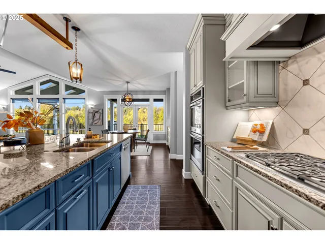 a kitchen with stainless steel appliances granite countertop a stove a sink dishwasher and cabinets