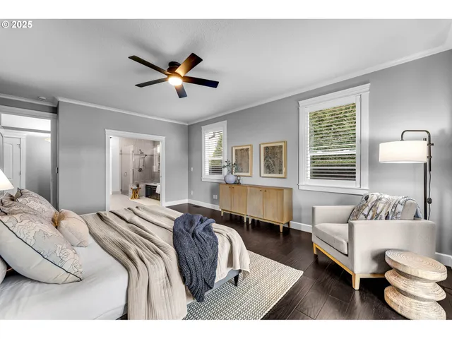 a spacious bedroom with a bed a couch and a chandelier