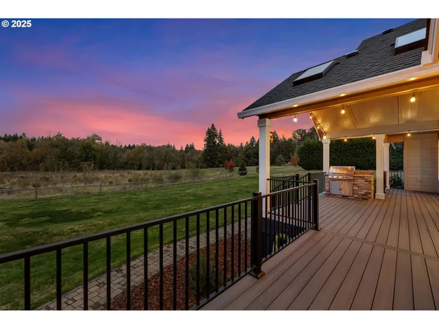 a balcony with wooden floor table and chairs