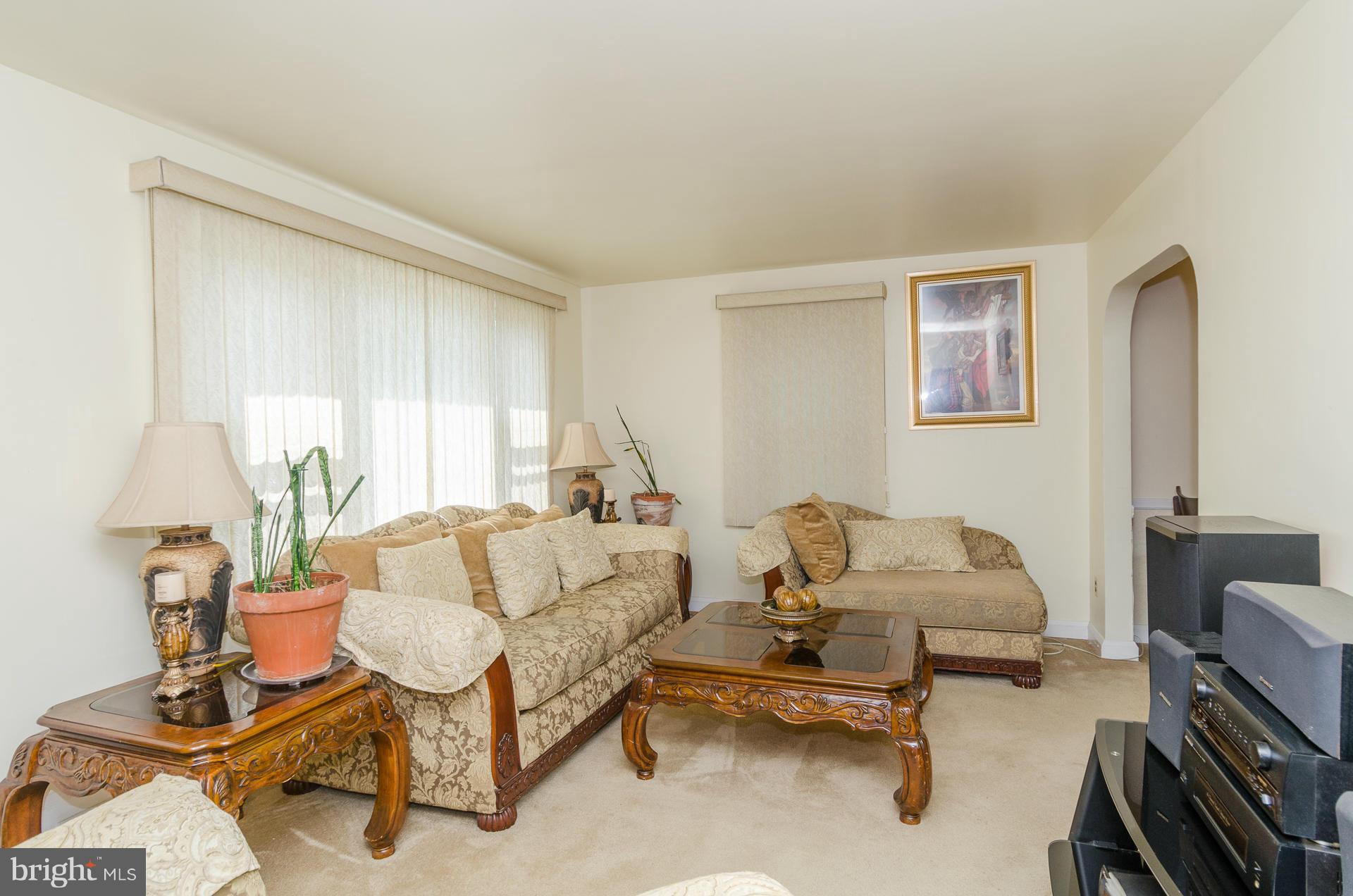 3522 Wild Cherry Road Baltimore, MD 21244 - Photo 2 of 30 a living room with furniture and a lamp