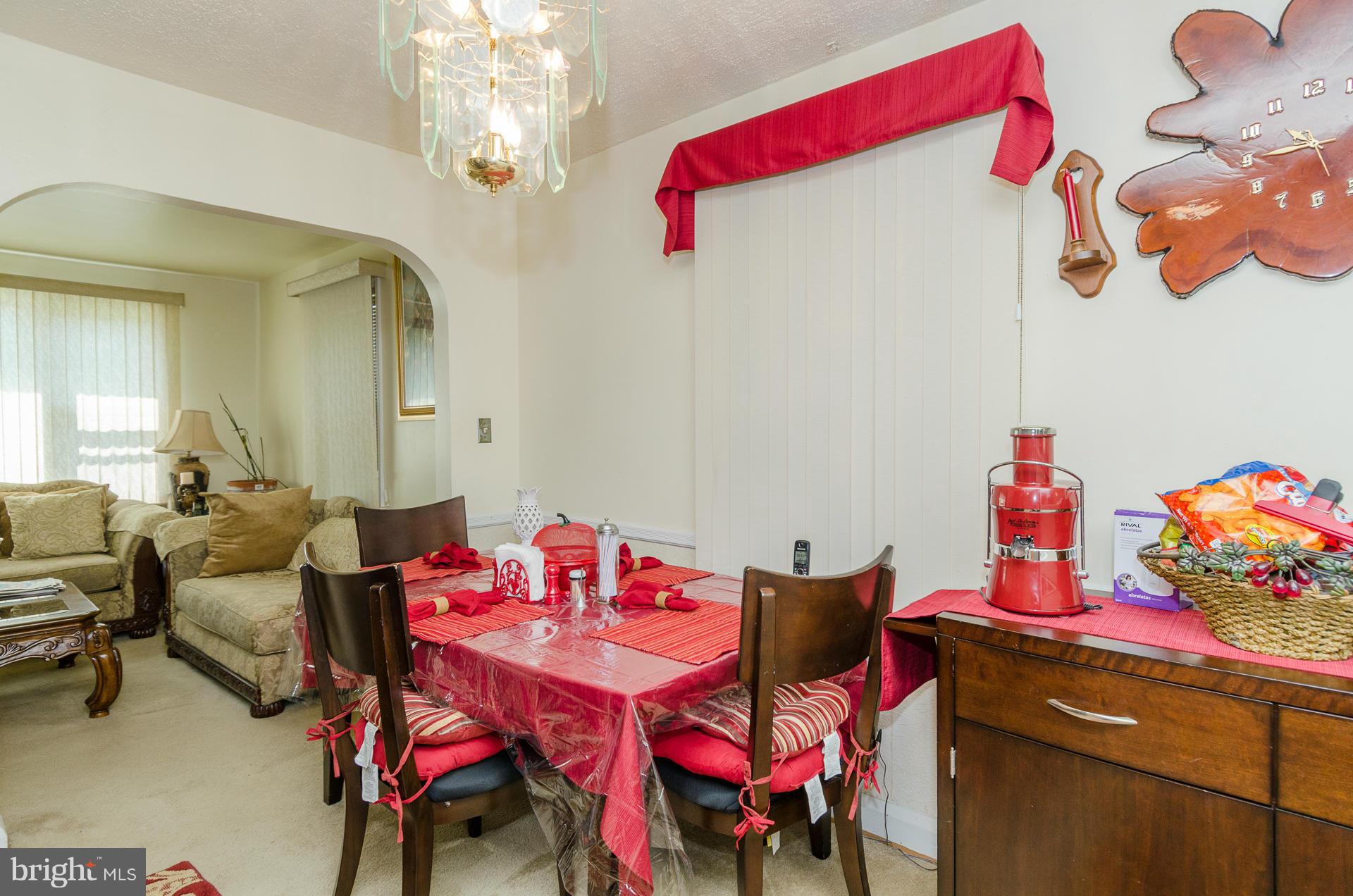 3522 Wild Cherry Road Baltimore, MD 21244 - Photo 11 of 30 a view of a dining room with furniture and chandelier