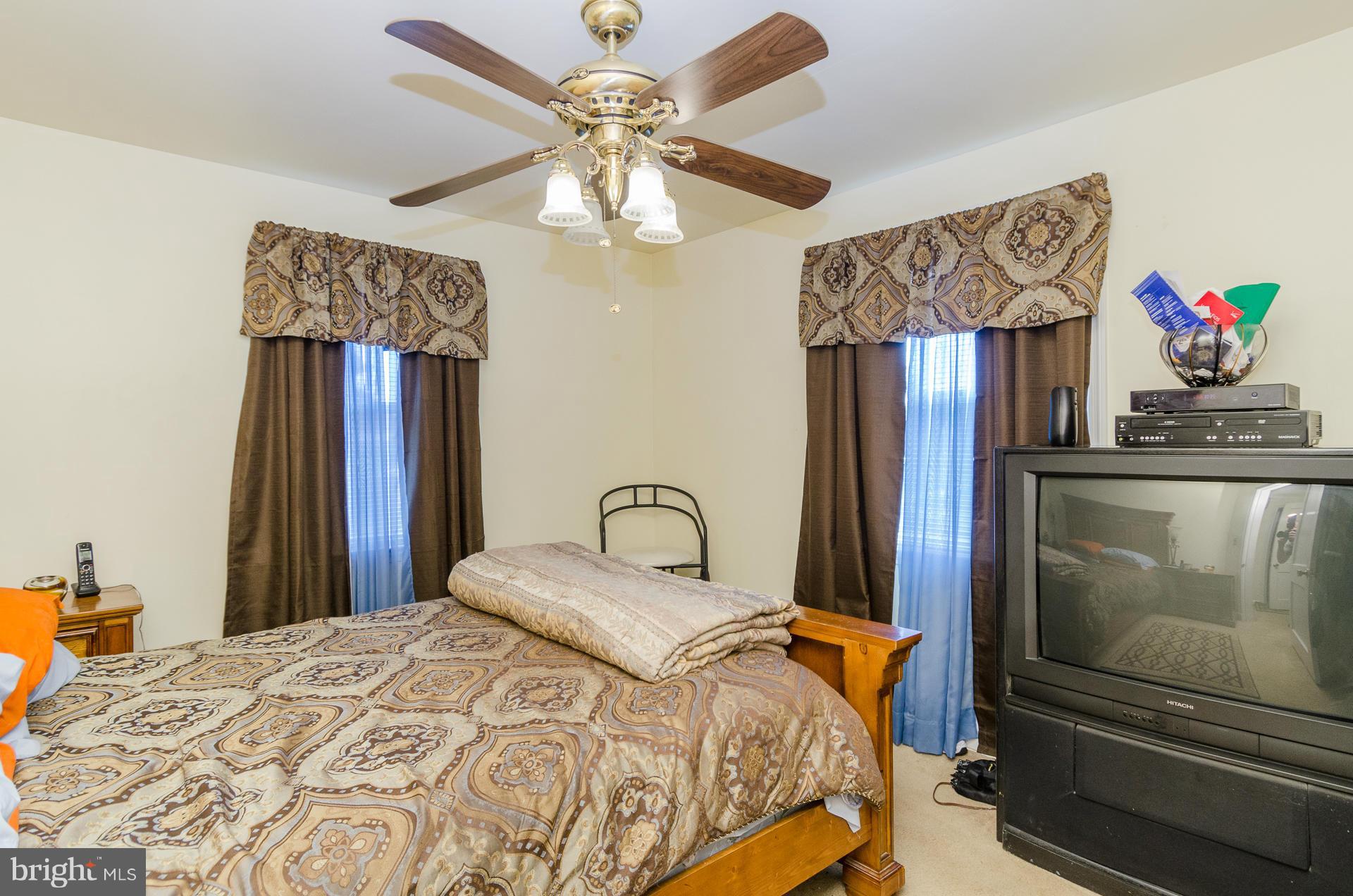 3522 Wild Cherry Road Baltimore, MD 21244 - Photo 12 of 30 a bedroom with a bed and dresser