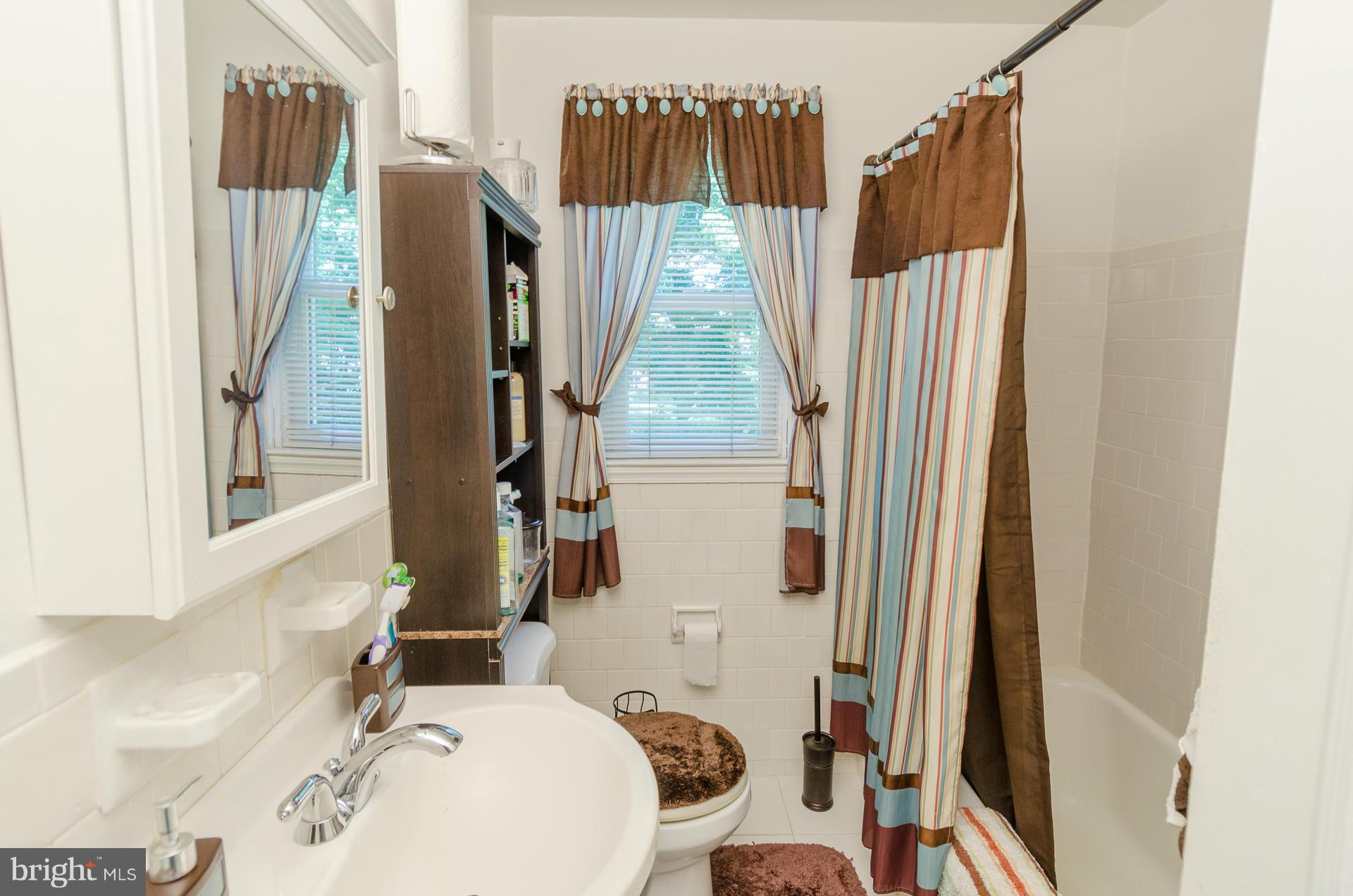 3522 Wild Cherry Road Baltimore, MD 21244 - Photo 15 of 30 a bathroom with a sink toilet and shower