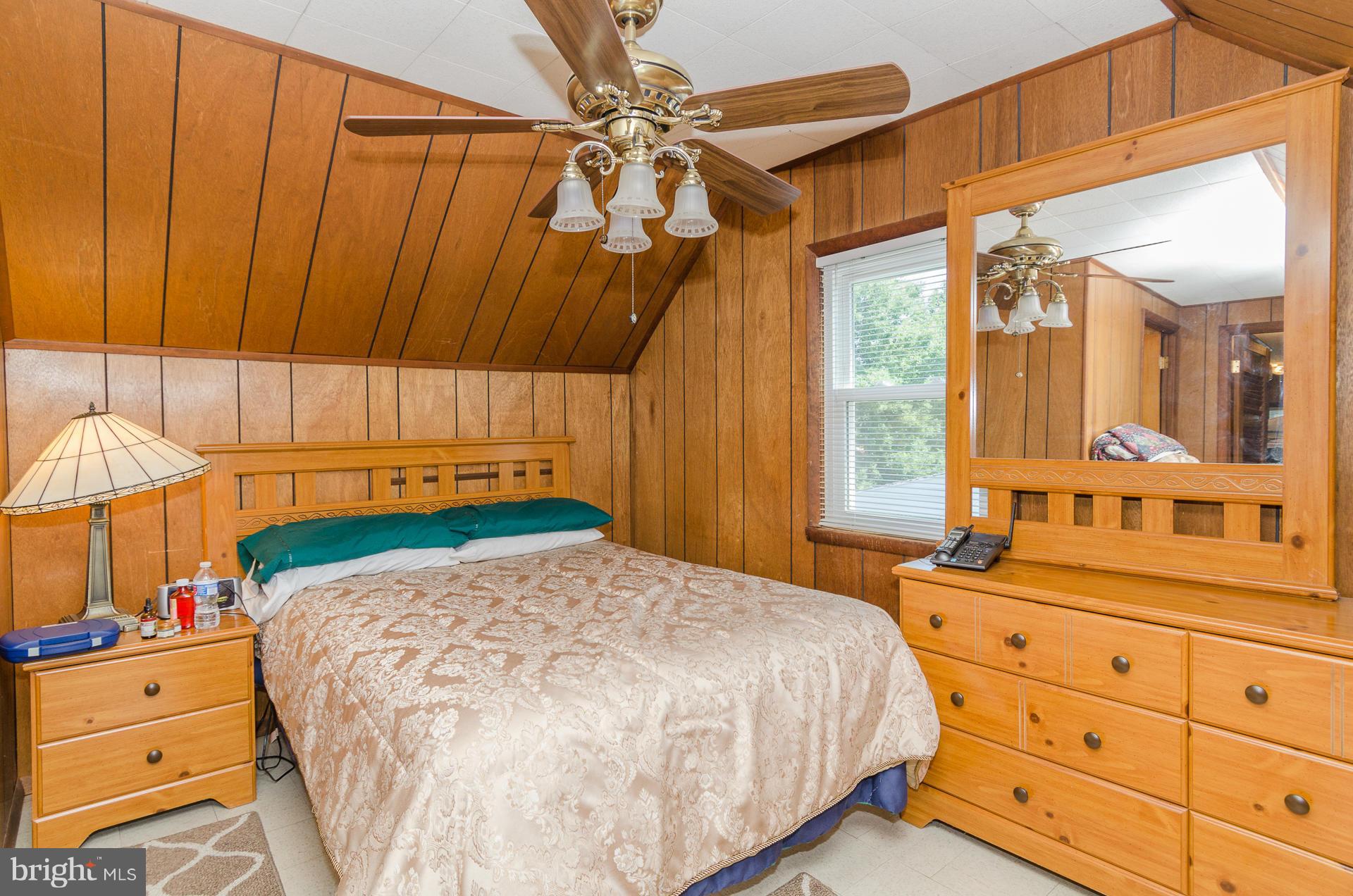 3522 Wild Cherry Road Baltimore, MD 21244 - Photo 20 of 30 a bed sitting in a bedroom next to a window